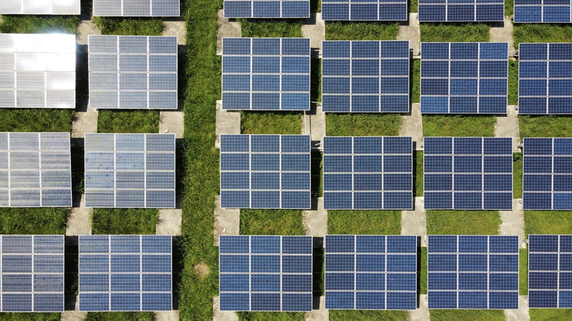 aerial shot of solar panels on grass